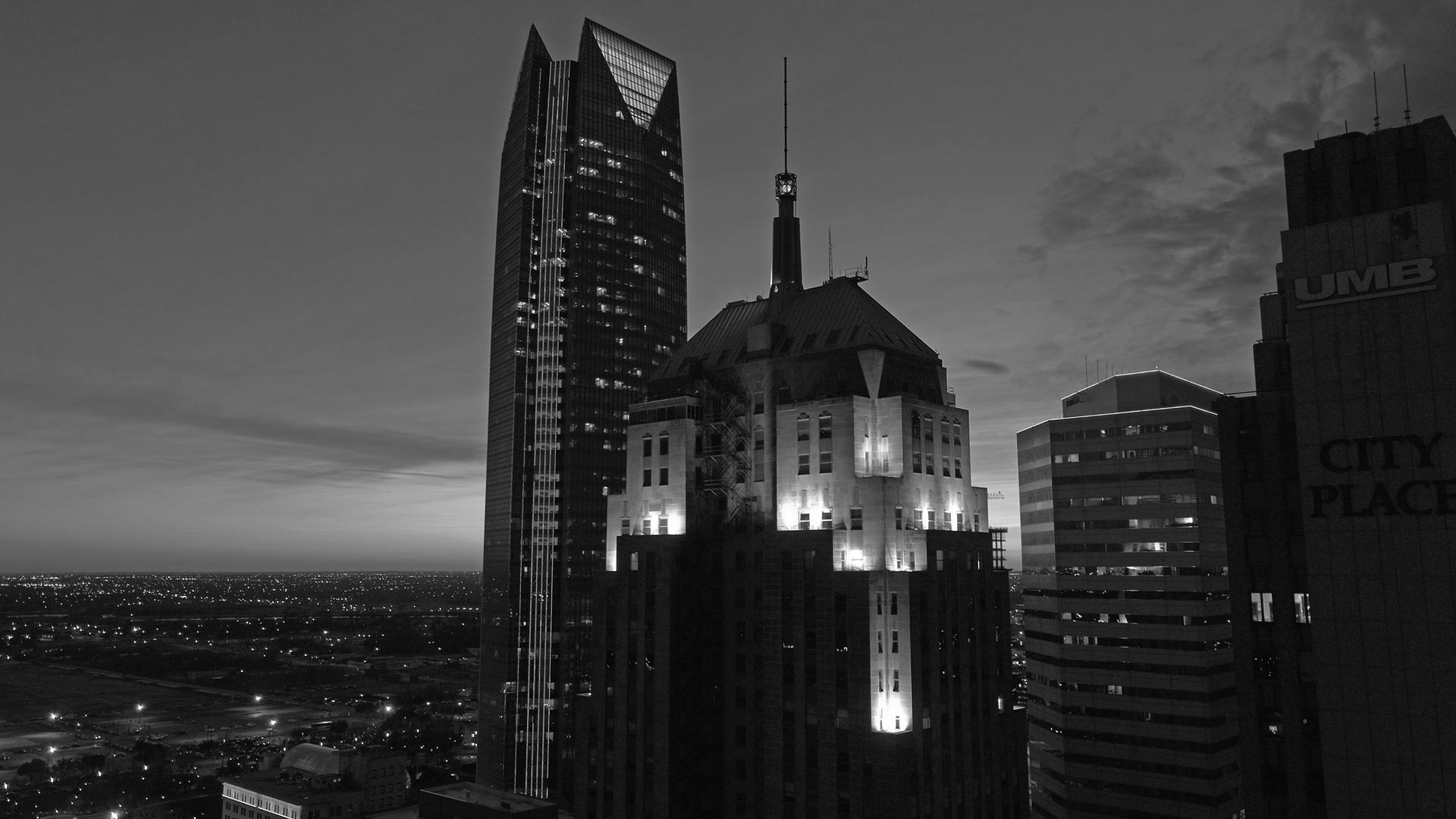 black and white photo of city skyline at night at The  First