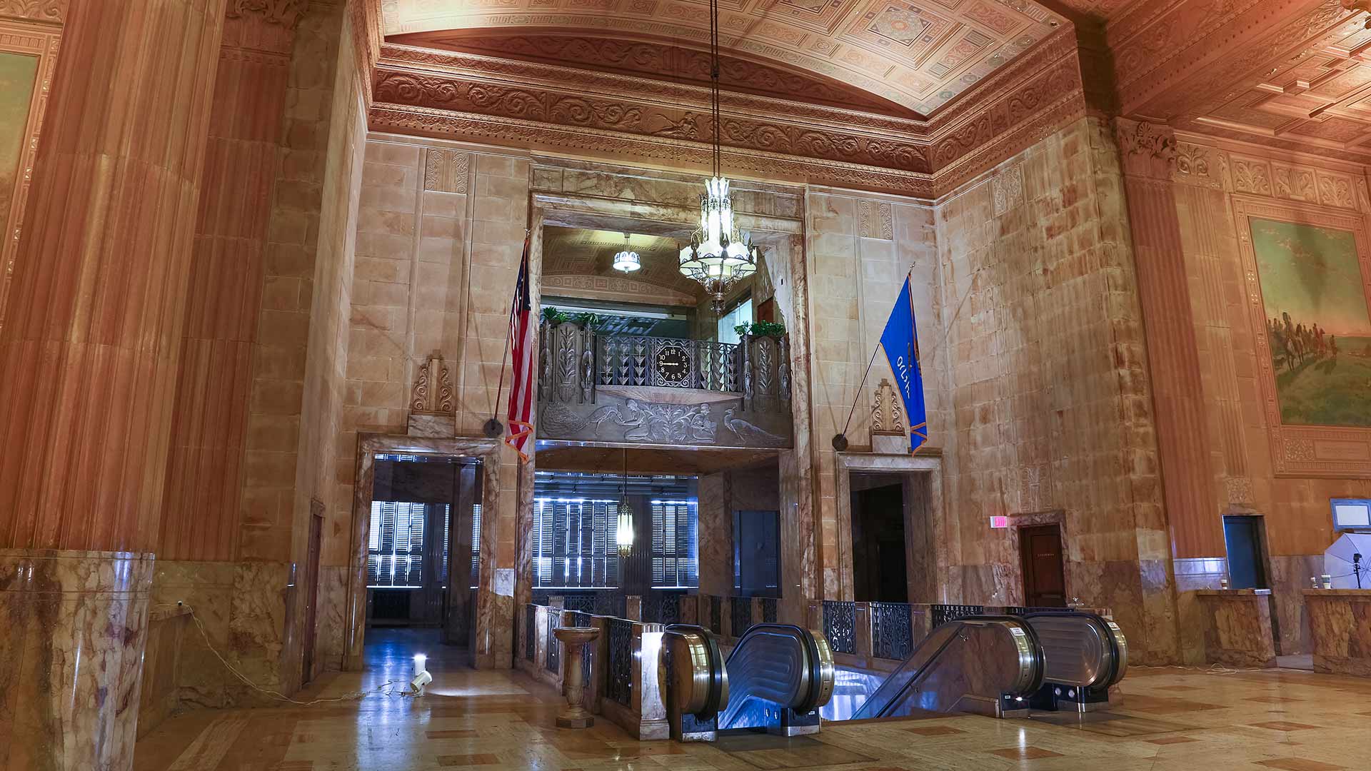 the lobby of a building with a large clock at The  First