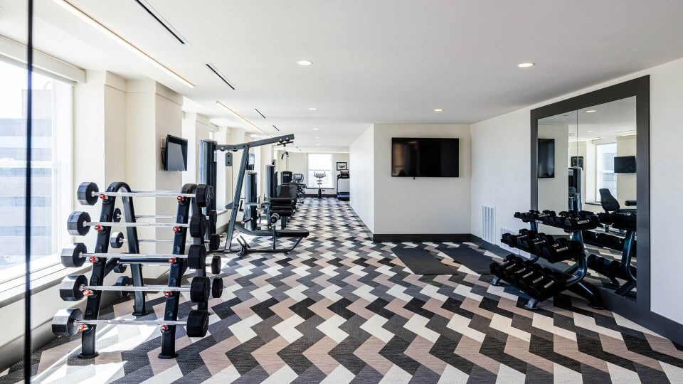 a gym room with a black and white checkered floor at The  First
