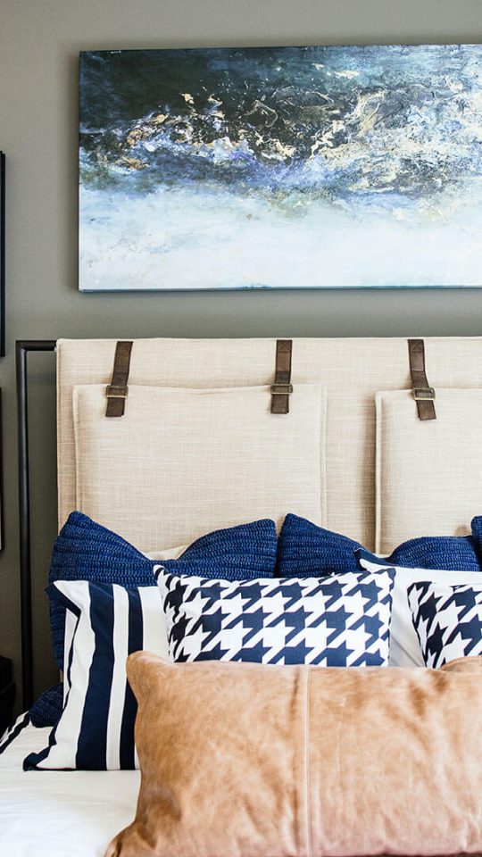 a bedroom with a bed, nightstands, and pictures on the wall at The  First