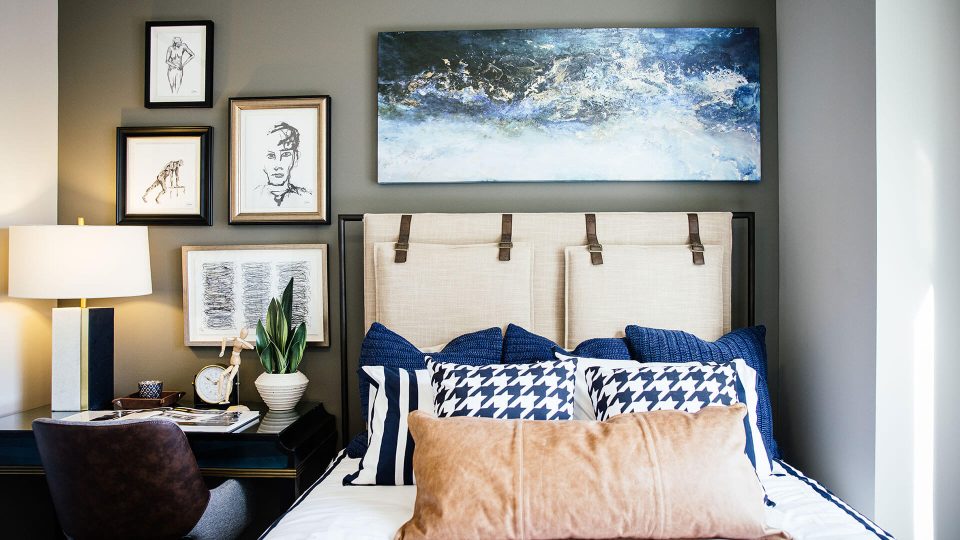 a bedroom with a bed, nightstands, and pictures on the wall at The  First