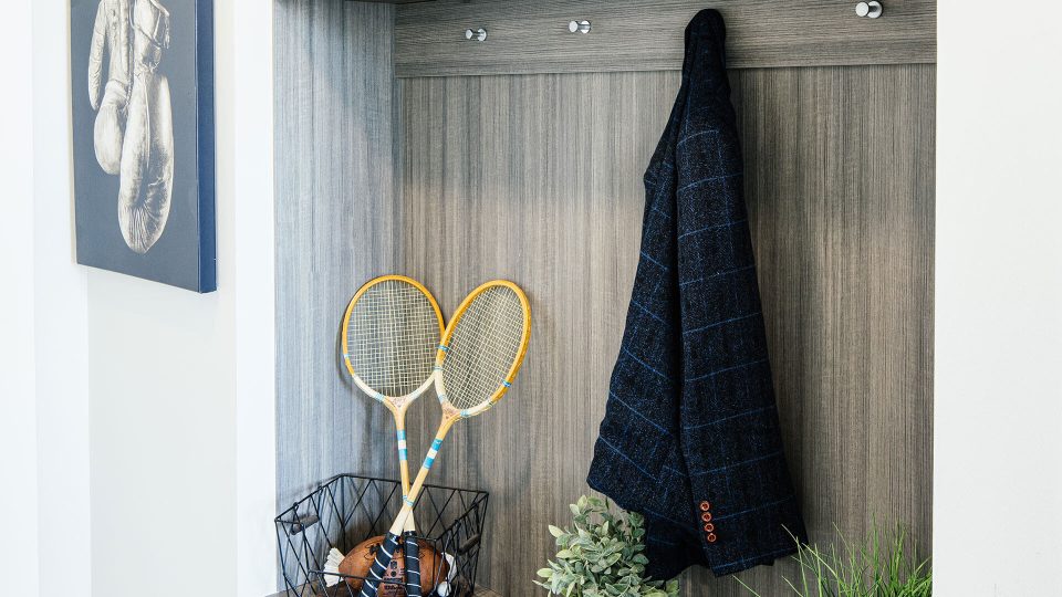 a tennis racket and tennis balls are displayed in a cabinet at The  First