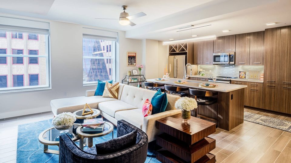 a living room and kitchen area with a large window at The  First