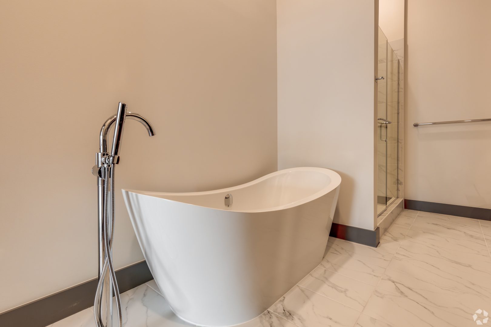 a bathroom with a bath tub and shower stall at The  First