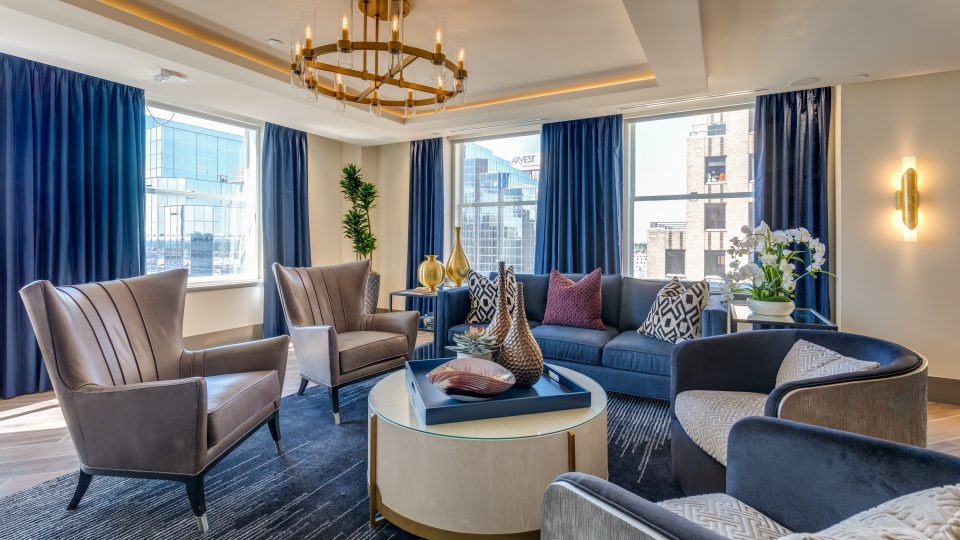 a living room with blue and gold accents at The  First