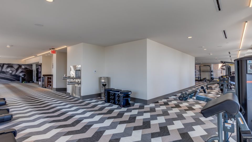 a gym room with a black and white checkered floor at The  First
