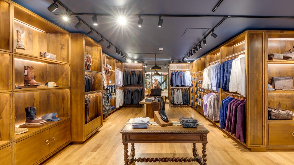 a clothing store with wooden floors and wooden shelves at The  First