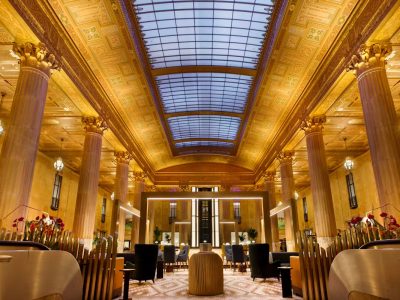 the lobby of a hotel with a large ceiling at The  First