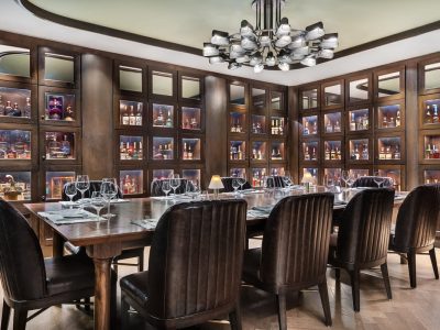a dining room with a large table and chairs at Stock and Bond OKC