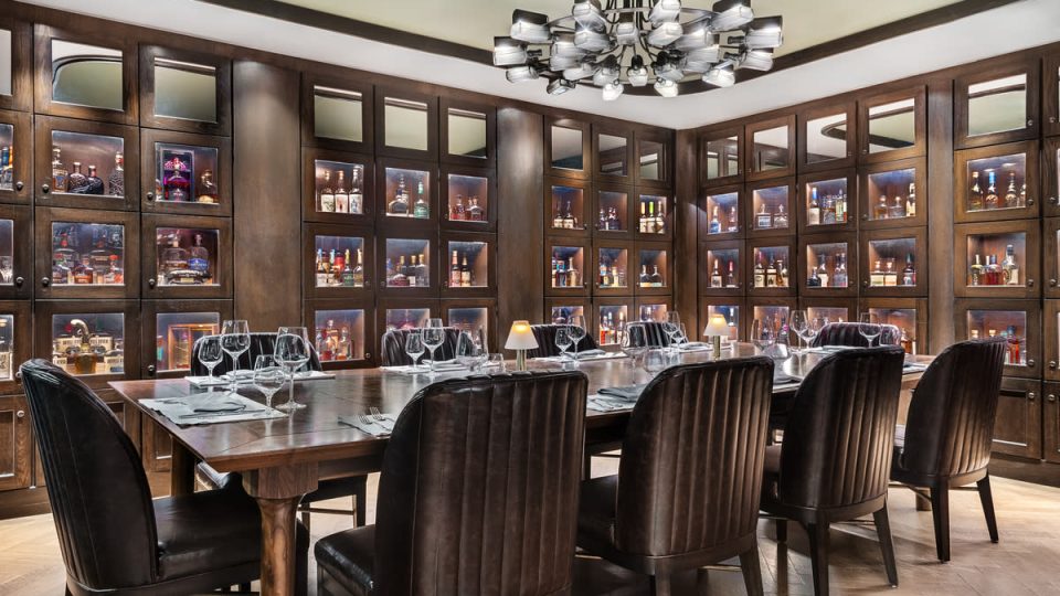 a dining room with a large table and chairs at Stock and Bond OKC